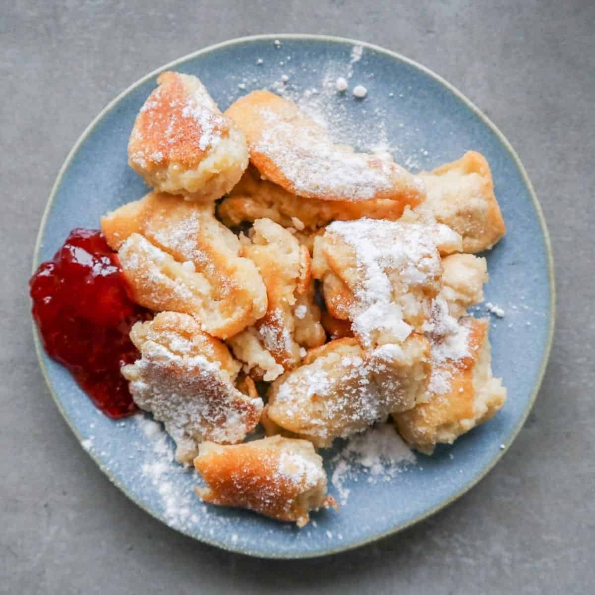 Kaiserschmarrn with jam and powdered sugar.