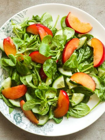 Cucumber salad with plums and greens.