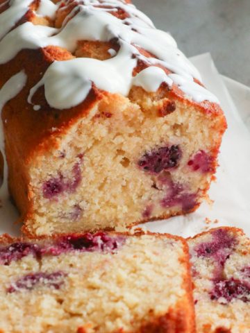 Two slices of lemon cake with blackberries.