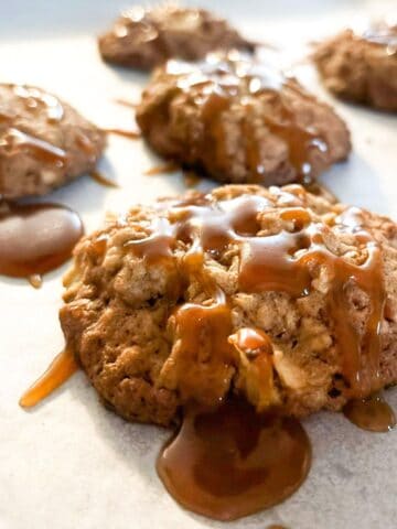 Apple caramel oatmeal cookies on a baking sheet.