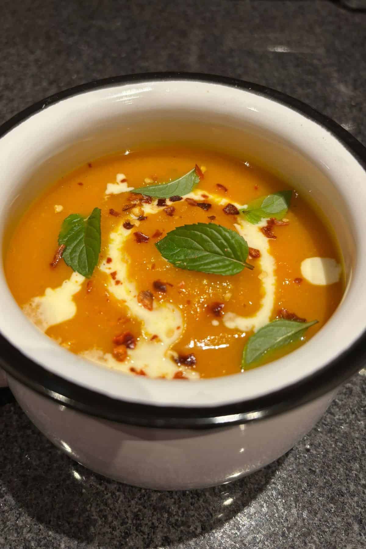 Butternut squash and carrot soup in a bowl.